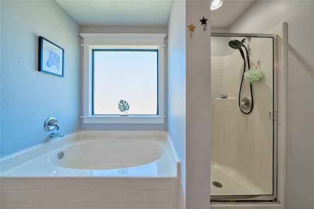 bathroom with a healthy amount of sunlight and a stall shower