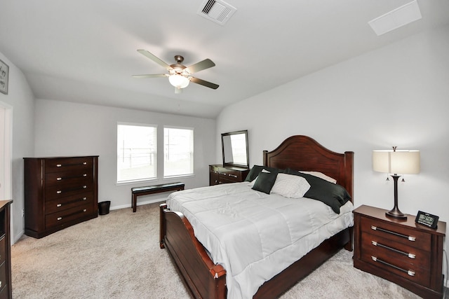 bedroom featuring baseboards, ceiling fan, light colored carpet, and visible vents