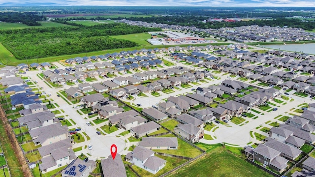 drone / aerial view featuring a water view and a residential view