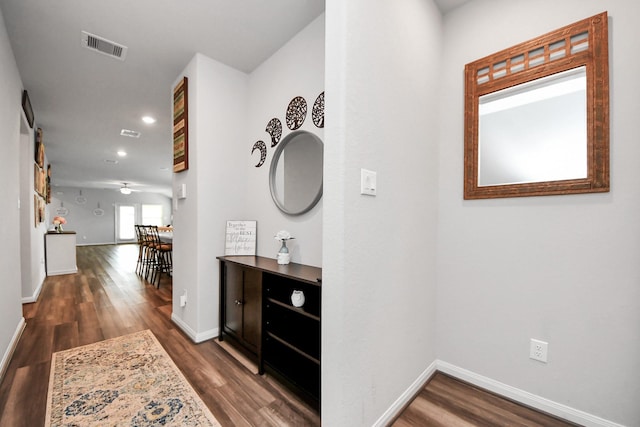 corridor with visible vents, recessed lighting, baseboards, and wood finished floors
