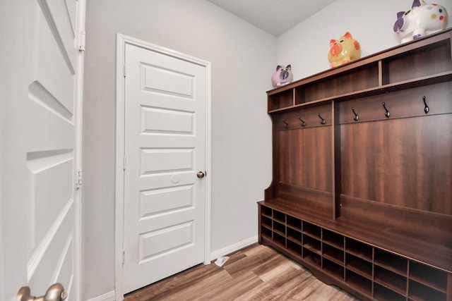 mudroom featuring baseboards and light wood finished floors