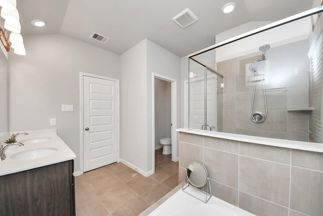 full bathroom with toilet, visible vents, a sink, and a stall shower