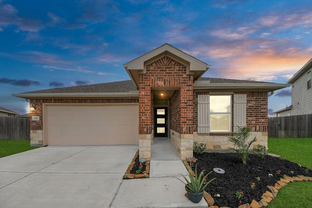 view of front of house featuring brick siding, an attached garage, fence, and stone siding