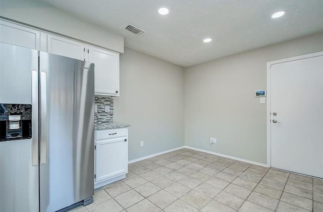 kitchen featuring decorative backsplash, stainless steel refrigerator with ice dispenser, visible vents, white cabinets, and recessed lighting