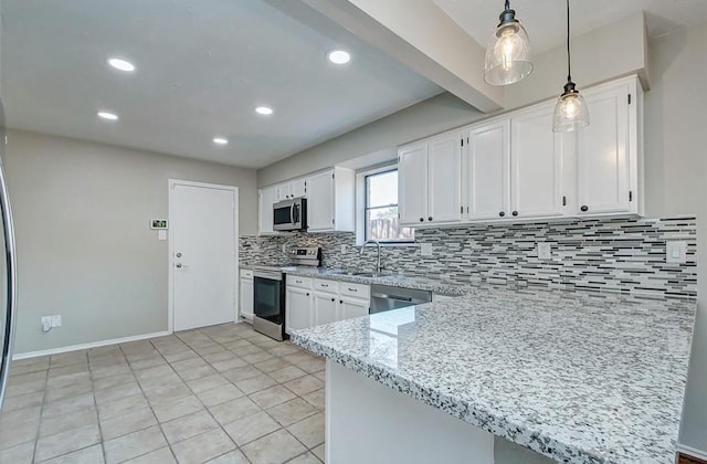 kitchen with appliances with stainless steel finishes, decorative backsplash, and white cabinetry