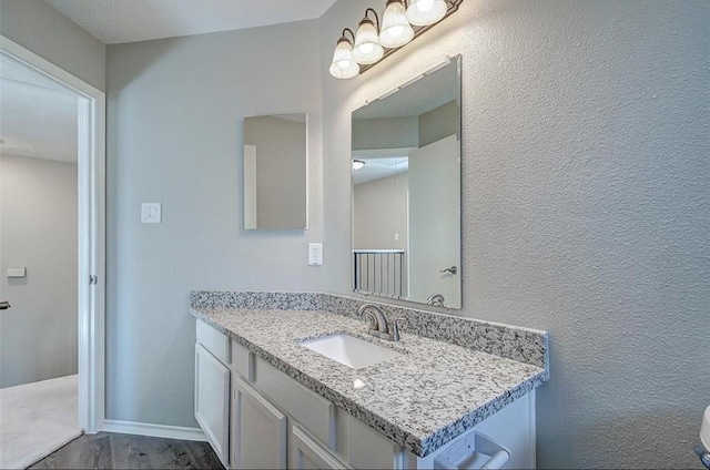 bathroom featuring vanity and wood finished floors