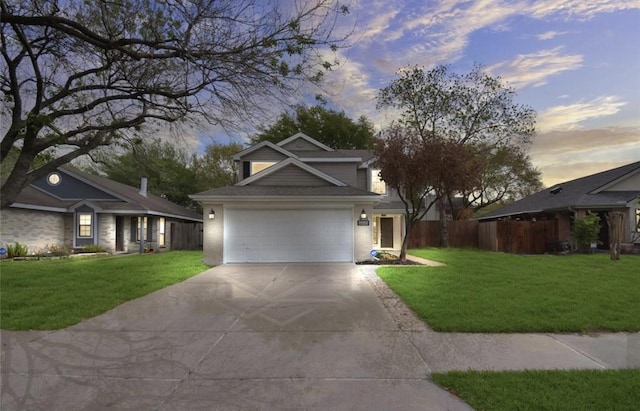 traditional home with fence, concrete driveway, and a front yard