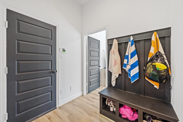 mudroom with baseboards and wood finished floors