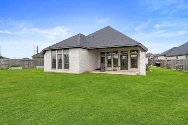 rear view of house with a shingled roof, brick siding, ceiling fan, a fenced backyard, and a patio area