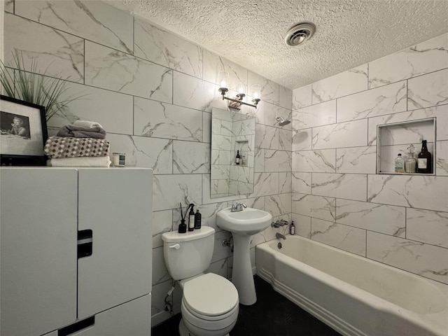 full bathroom featuring a textured ceiling, shower / washtub combination, toilet, and tile walls