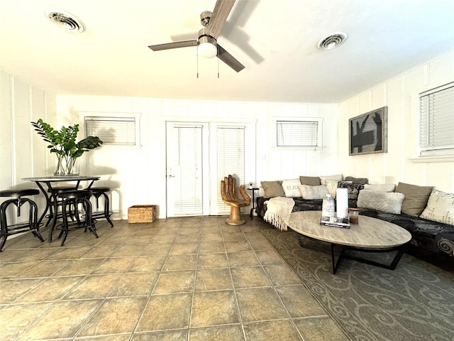 living room featuring visible vents, ceiling fan, and tile patterned flooring