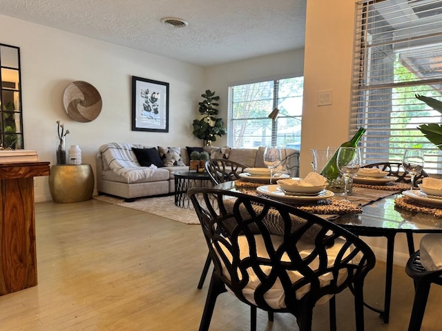7006 Jalna St, Houston, TX 77055 - dining space featuring wood finished floors and a textured ceiling