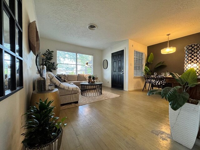 7006 Jalna St, Houston, TX 77055 - living area with wood finished floors, a textured ceiling, and baseboards