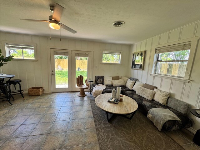 7006 Jalna St, Houston, TX 77055 - living area featuring plenty of natural light, a decorative wall, a ceiling fan, and a textured ceiling
