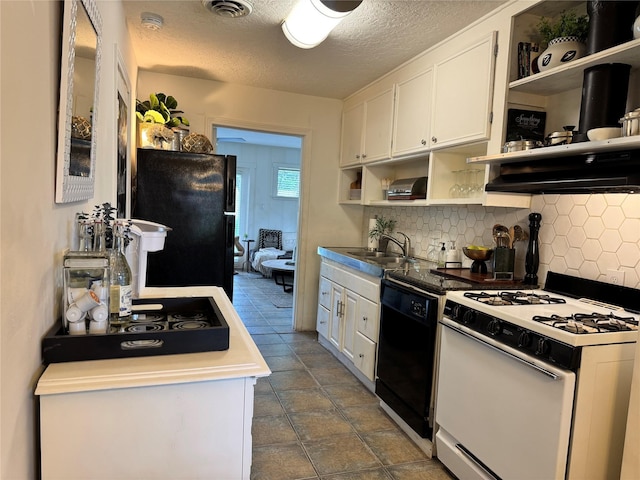 7006 Jalna St, Houston, TX 77055 - kitchen with black appliances, open shelves, a sink, tasteful backsplash, and white cabinets