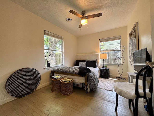 7006 Jalna St, Houston, TX 77055 - bedroom with hardwood / wood-style flooring, baseboards, a textured ceiling, and a ceiling fan