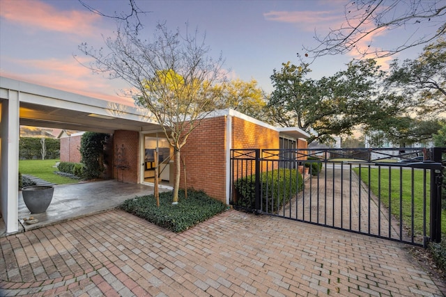 exterior space with fence and a lawn