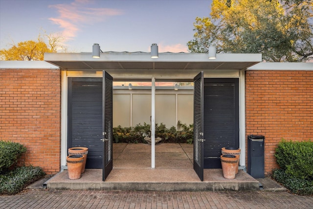 exterior space featuring brick siding and fence