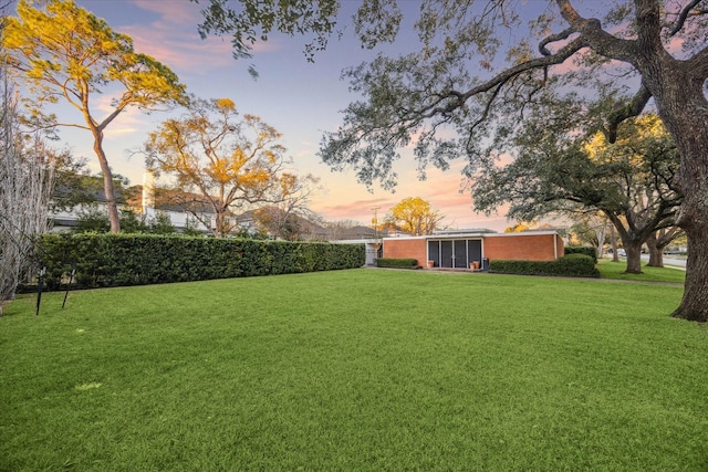 view of yard at dusk