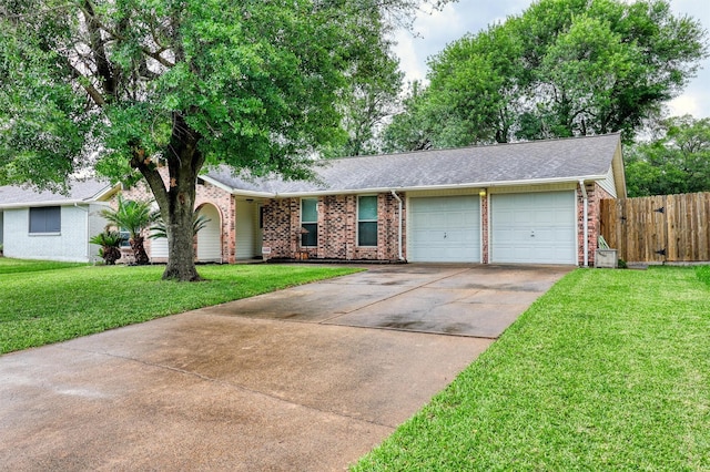 ranch-style home with driveway, a front yard, a garage, brick siding, and fence