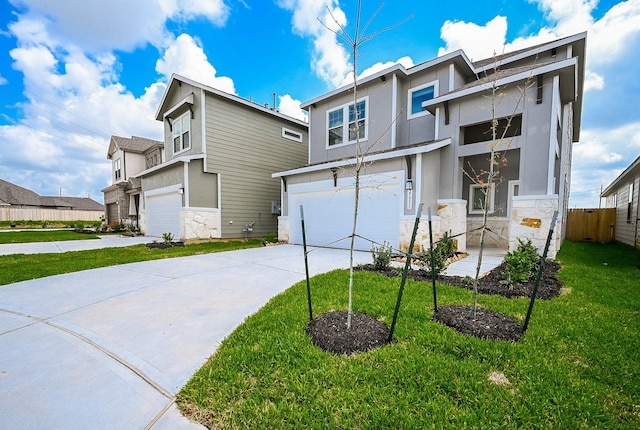 view of front of home featuring a front lawn, stone siding, stucco siding, an attached garage, and driveway