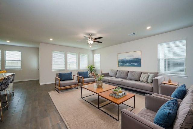 living area with baseboards, a ceiling fan, recessed lighting, and dark wood-type flooring