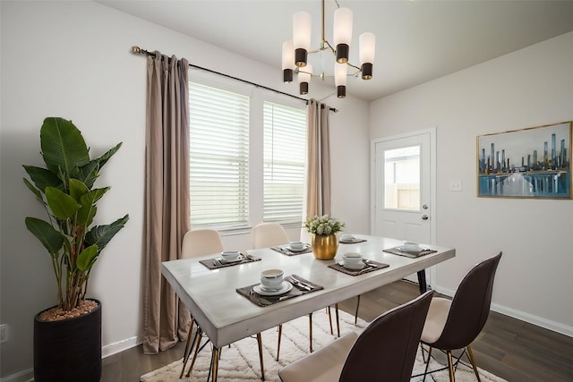 dining room featuring baseboards, dark wood-type flooring, and a chandelier