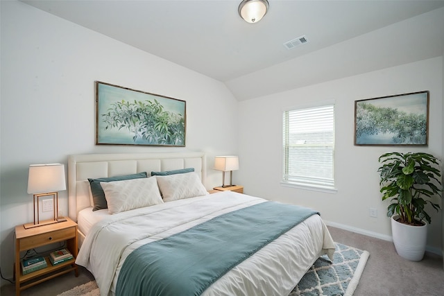 carpeted bedroom with baseboards, lofted ceiling, and visible vents