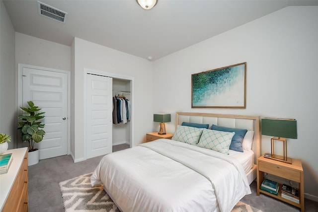 carpeted bedroom with visible vents and a closet