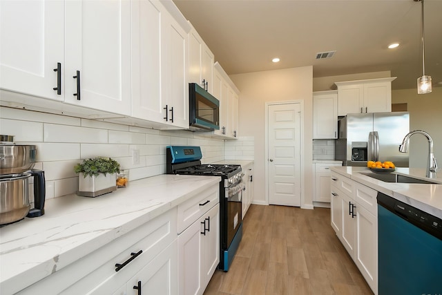 21807 Ash Cypress Ct, Cypress, TX 77433 - kitchen featuring appliances with stainless steel finishes, a sink, tasteful backsplash, recessed lighting, and white cabinets