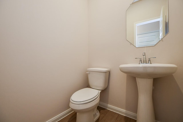 21807 Ash Cypress Ct, Cypress, TX 77433 - bathroom featuring wood finished floors, baseboards, toilet, and a sink