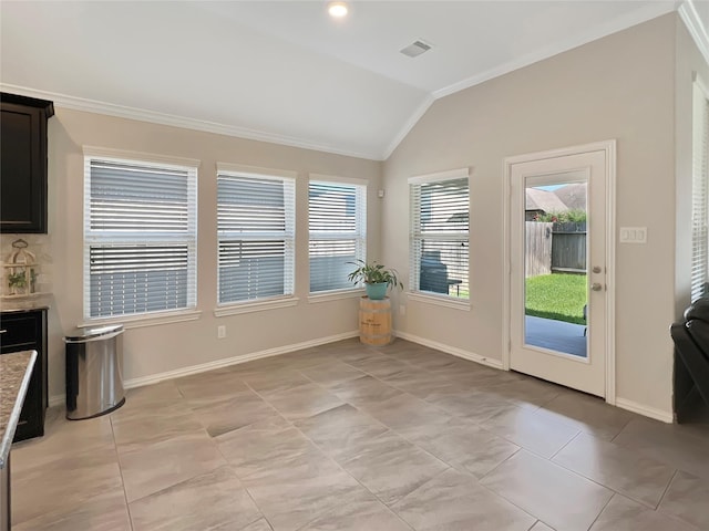 entryway with visible vents, crown molding, vaulted ceiling, baseboards, and light tile patterned flooring