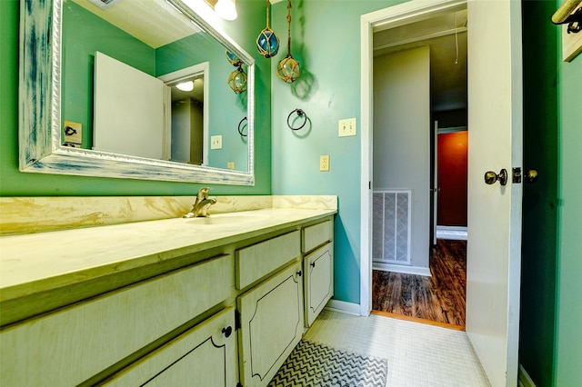 bathroom with visible vents, baseboards, tile patterned floors, and vanity