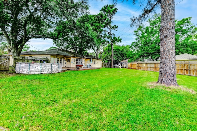 view of yard featuring a fenced backyard and a swimming pool