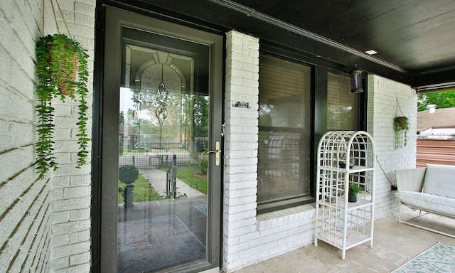 view of exterior entry with brick siding