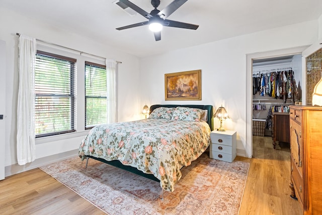 bedroom featuring baseboards, light wood-type flooring, and visible vents
