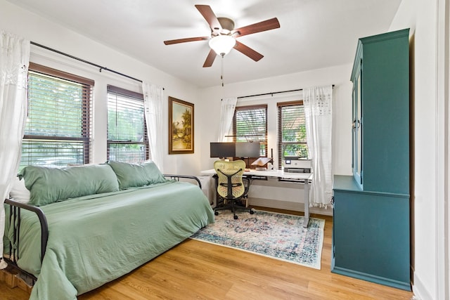 bedroom with light wood-style flooring and ceiling fan