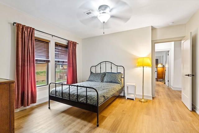 bedroom featuring baseboards, visible vents, ceiling fan, and light wood-type flooring