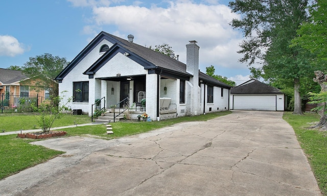 view of front facade with an outdoor structure, a front yard, a chimney, brick siding, and a porch