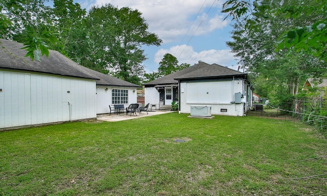 back of house with fence, a patio, roof with shingles, entry steps, and a yard