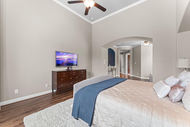 bedroom featuring arched walkways, wood finished floors, high vaulted ceiling, baseboards, and ornamental molding