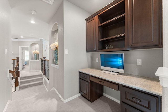 office space with crown molding, built in desk, baseboards, light carpet, and recessed lighting
