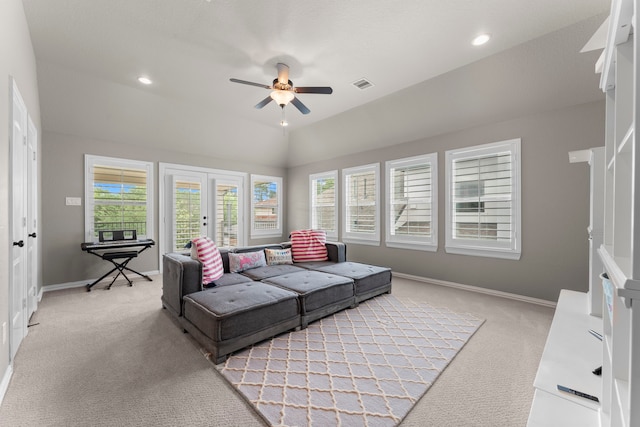 living area featuring light colored carpet, a ceiling fan, visible vents, and french doors