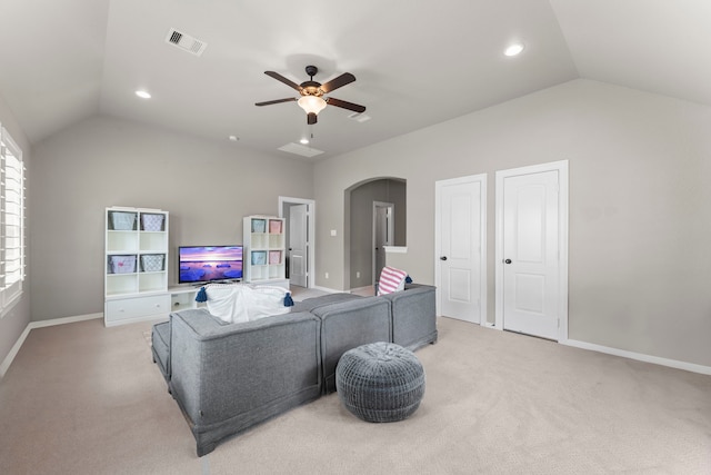 living room featuring visible vents, ceiling fan, vaulted ceiling, and light colored carpet