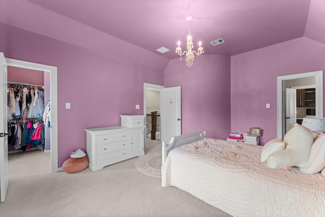 bedroom featuring a walk in closet, light carpet, vaulted ceiling, and visible vents