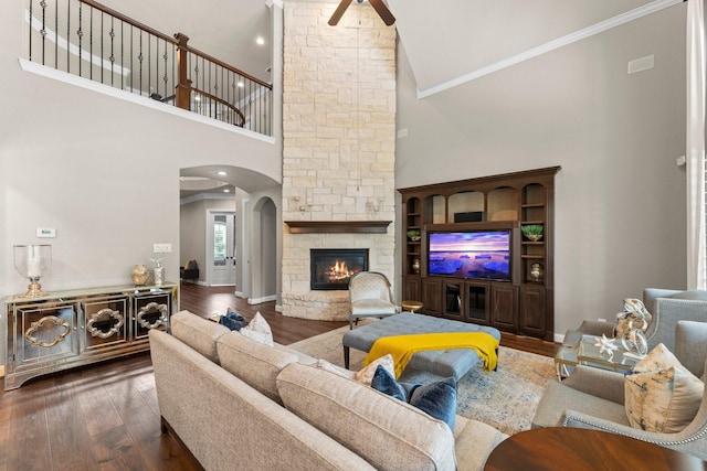living area featuring high vaulted ceiling, a ceiling fan, arched walkways, and wood finished floors