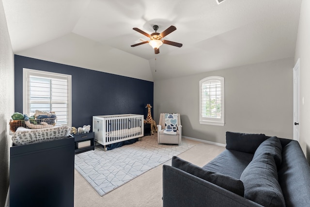 bedroom featuring a ceiling fan, vaulted ceiling, and light colored carpet