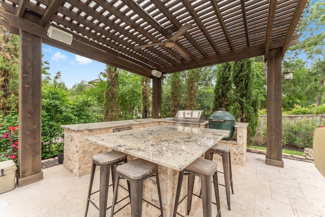 view of patio / terrace featuring an outdoor bar, grilling area, exterior kitchen, and a pergola