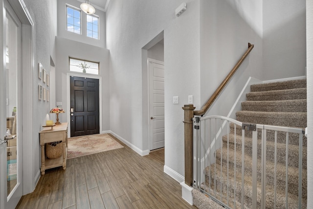 4381 Victoria Pine Dr, Spring, TX 77386 - foyer entrance featuring wood finished floors, baseboards, stairway, and a high ceiling