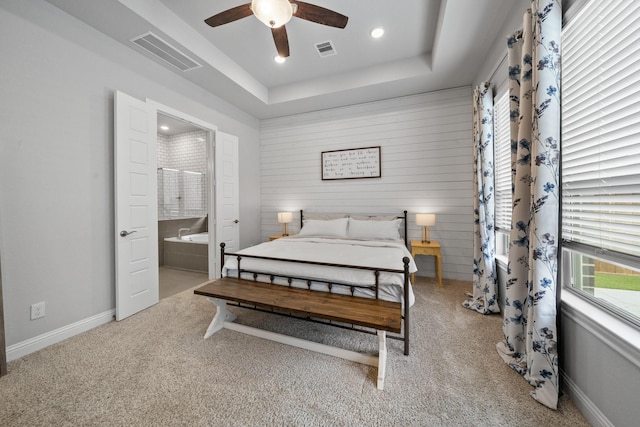 4381 Victoria Pine Dr, Spring, TX 77386 - carpeted bedroom featuring recessed lighting, connected bathroom, baseboards, a tray ceiling, and ceiling fan